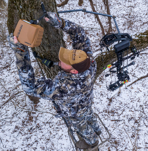 Hunter Installing The Hr230 Scent-ElimiDynamically created pageting Ozone Generator Device On A Tree.
